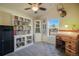 Office with a ceiling fan, desk, and white bookshelf filled with books, plus a window overlooking the outdoors at 819 Meadow Ln, Palmer Lake, CO 80133