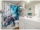 Modern bathroom featuring a vanity, toilet, and blue shower curtain at 2281 S Vaughn Way # 316A, Aurora, CO 80014