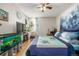 Bright bedroom features a ceiling fan, a TV, and laminate flooring at 2281 S Vaughn Way # 316A, Aurora, CO 80014