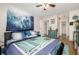 Well-lit bedroom with a bed, blue accents, and access to closets and the bathroom at 2281 S Vaughn Way # 316A, Aurora, CO 80014