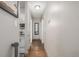 Clean hallway featuring hardwood floors, a mirror, and access to the kitchen at 2281 S Vaughn Way # 316A, Aurora, CO 80014