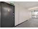 Hallway view featuring gray carpet and black apartment door with exit sign at 2281 S Vaughn Way # 316A, Aurora, CO 80014