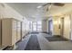 Hallway view showcasing mailbox, carpet and exit sign with elevator access at 2281 S Vaughn Way # 316A, Aurora, CO 80014