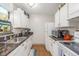 Galley kitchen features white cabinets, granite counters, and sleek stainless steel appliances at 2281 S Vaughn Way # 316A, Aurora, CO 80014
