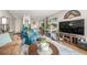 Inviting living room with a sofa, armchairs, a television, plants and a striking blue rug at 2281 S Vaughn Way # 316A, Aurora, CO 80014