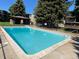 A clear, inviting swimming pool is surrounded by lush greenery and a shaded gazebo at 2281 S Vaughn Way # 316A, Aurora, CO 80014