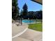 Outdoor pool surrounded by a fence for safety, trees, and plenty of space for lounging at 2281 S Vaughn Way # 316A, Aurora, CO 80014