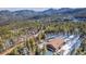 Wide aerial view of a home surrounded by lush forests, showcasing its scenic location at 255 Divide View Dr, Golden, CO 80403