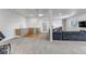Finished basement with a kitchenette, large gray sofa and walk-out to exterior at 255 Divide View Dr, Golden, CO 80403