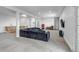 Spacious finished basement features a gray sofa, TV, kitchenette, and walk-out to exterior at 255 Divide View Dr, Golden, CO 80403