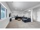 Finished basement with gray sectional sofa, window view to the exterior and ski equipment at 255 Divide View Dr, Golden, CO 80403