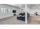 Finished basement featuring a large gray sectional sofa, a TV, and a walkout to the exterior at 255 Divide View Dr, Golden, CO 80403