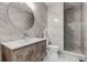 Sleek bathroom showcasing a vanity with a vessel sink, a round mirror and a glass-enclosed shower at 255 Divide View Dr, Golden, CO 80403