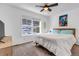 Bright bedroom with a queen-sized bed, ceiling fan and a large window overlooking a forest at 255 Divide View Dr, Golden, CO 80403
