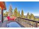 Enjoy mountain views on this wood deck with charming red Adirondack chairs at 255 Divide View Dr, Golden, CO 80403