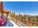 Enjoy mountain views from this wood deck with charming red Adirondack chairs at 255 Divide View Dr, Golden, CO 80403