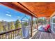 Relax on the covered wood deck overlooking mountain views and a hammock at 255 Divide View Dr, Golden, CO 80403