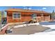 Cabin exterior with hot tub, a small deck and lush mountain views at 255 Divide View Dr, Golden, CO 80403