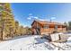 Mountain cabin exterior with deck, outdoor seating and a luxurious hot tub at 255 Divide View Dr, Golden, CO 80403