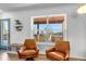 Inviting living area with arm chairs and views of the outdoor scenery at 255 Divide View Dr, Golden, CO 80403