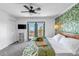 Bedroom with a leafy wallpaper accent wall, outdoor access, and scenic mountain views at 255 Divide View Dr, Golden, CO 80403