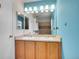 Bathroom featuring a dual sink vanity with a tile shower in the background at 9595 Elk Mountain Cir, Littleton, CO 80125