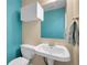 Bright half bath features modern sink, toilet, mirror, and vanity at 9595 Elk Mountain Cir, Littleton, CO 80125