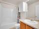 Bathroom features a vanity, white tiled shower, and modern shower curtain at 9595 Elk Mountain Cir, Littleton, CO 80125