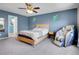 Bedroom with a bed, a nightstand, a massage chair, carpet, and a ceiling fan at 9595 Elk Mountain Cir, Littleton, CO 80125