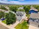Aerial view of a suburban home with solar panels, lush lawn, and established landscaping, set amongst neighboring houses at 9595 Elk Mountain Cir, Littleton, CO 80125