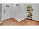 Hardwood foyer with decorative plant stand and white door entrance at 9595 Elk Mountain Cir, Littleton, CO 80125