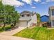 Charming two-story home with a well-manicured lawn and attached two-car garage at 9595 Elk Mountain Cir, Littleton, CO 80125