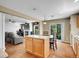 Bright kitchen with light floors connects to a living area with a television and fireplace at 9595 Elk Mountain Cir, Littleton, CO 80125