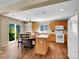 Open kitchen features wood floors, a center island, and a dining area with sliding glass doors at 9595 Elk Mountain Cir, Littleton, CO 80125