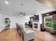 Spacious room with hardwood floors, fireplace, and entertainment area at 9595 Elk Mountain Cir, Littleton, CO 80125