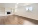 Finished basement featuring wood floors, painted brick fireplace, and built-in shelving at 8925 Oakwood St, Westminster, CO 80031