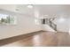 Spacious basement with wood floors and stairwell leading upstairs at 8925 Oakwood St, Westminster, CO 80031
