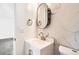 Updated bathroom featuring a stylish vanity, a black framed mirror, and modern fixtures at 8925 Oakwood St, Westminster, CO 80031