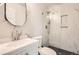 Modern bathroom featuring marble-patterned walls, a glass shower enclosure, and modern vanity at 8925 Oakwood St, Westminster, CO 80031