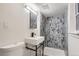 Modern bathroom featuring walk-in shower and unique, patterned tile at 8925 Oakwood St, Westminster, CO 80031