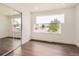 Bedroom featuring hardwood floors, a large window with neighborhood views, and mirrored closet doors at 8925 Oakwood St, Westminster, CO 80031