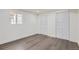 Bright bedroom with white walls, wood-look flooring, and large closet at 8925 Oakwood St, Westminster, CO 80031