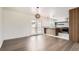 Dining area with hardwood floors, pendant lighting, and view into the modern kitchen at 8925 Oakwood St, Westminster, CO 80031