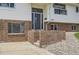 Inviting front entrance features brick accents, gray front door, and well-maintained landscaping at 8925 Oakwood St, Westminster, CO 80031