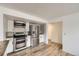 Modern kitchen featuring stainless steel appliances, white cabinetry, and updated backsplash at 8925 Oakwood St, Westminster, CO 80031