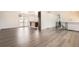 Spacious living area with hardwood floors, open layout, and access to kitchen and outdoor deck at 8925 Oakwood St, Westminster, CO 80031