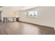 Bright living room with large windows, hardwood floors, and modern lighting fixtures at 8925 Oakwood St, Westminster, CO 80031