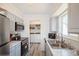Contemporary kitchen with stainless steel appliances, stylish cabinets, and laminate flooring at 2080 E 84Th Ave, Denver, CO 80229