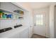 Convenient laundry area with modern appliances and shelving for storage at 2080 E 84Th Ave, Denver, CO 80229