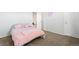 Bright bedroom with a pink bed, plush carpet, and a unicorn-themed decor at 3074 Kestrel St, Brighton, CO 80601